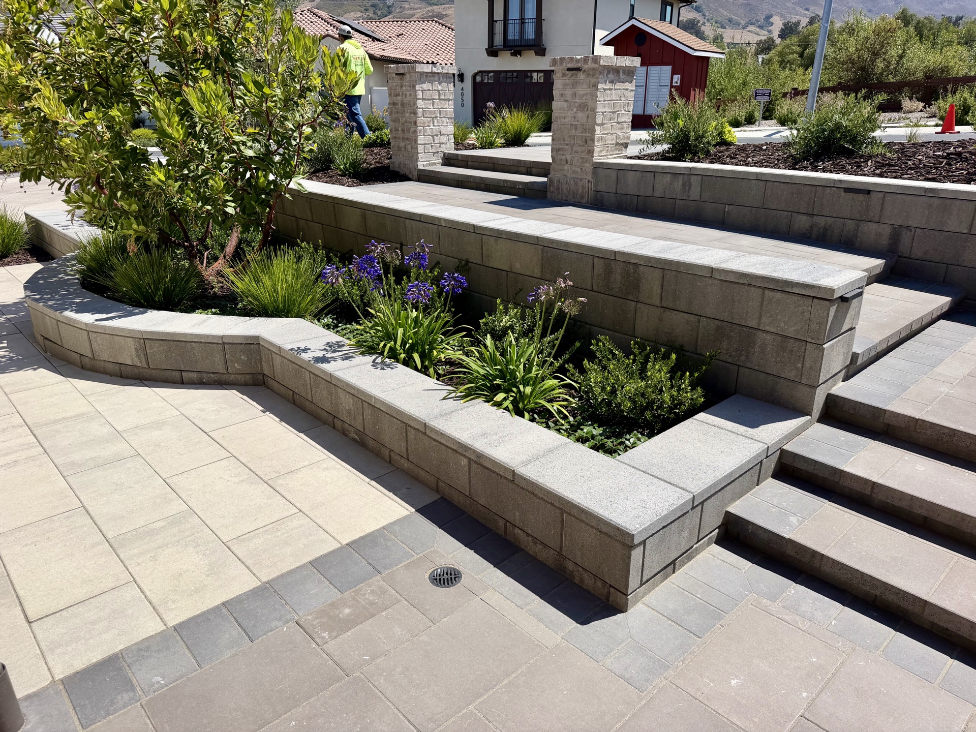 Multi-level stone retaining walls with agapanthus — New Era Landscape project